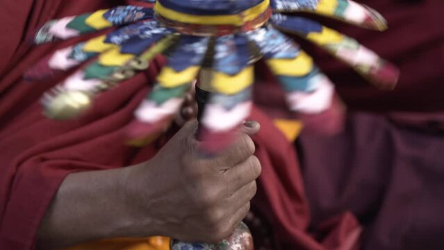 Hand holding a buddhist prayer wheel spinning fast. Tibetan buddhist, faith, compassion, love, Blessings, concept. Religion item.