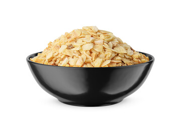 Dried garlic granules in black bowl isolated on white. Front view.