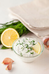 Sour cream sauce with dill and garlic in a bowl on the table. Organic food