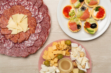 Different tasty snacks for party on wooden background, top view