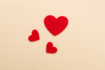 Felt hearts on color background, top view