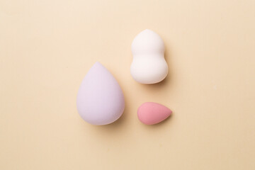 Beauty blenders on color background, top view