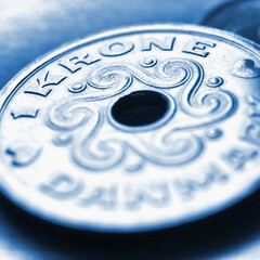 1 Danish krone coin close up. National currency of Denmark. Blue tinted square illustration for news about economy or finance. Banking and credit. Money and taxes. Macro