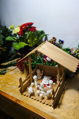  a small miniature christmas crib with burning candles