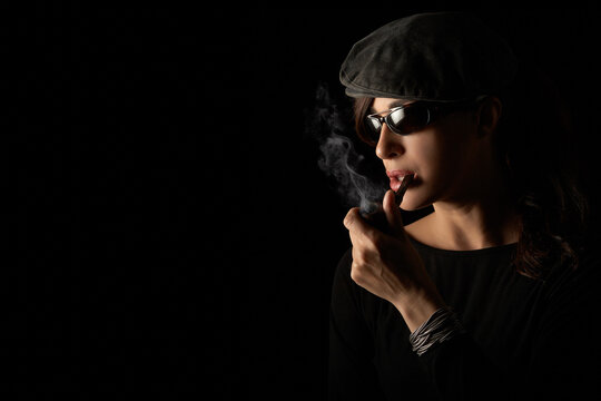 Pipe smoking day. Atractive hipster girl smoking vintage wooden pipe