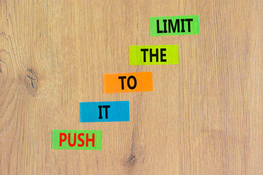 Push it to the limit symbol. Concept words Push it to the limit on colored paper. Beautiful wooden table wooden background. Business push it to the limit concept. Copy space.