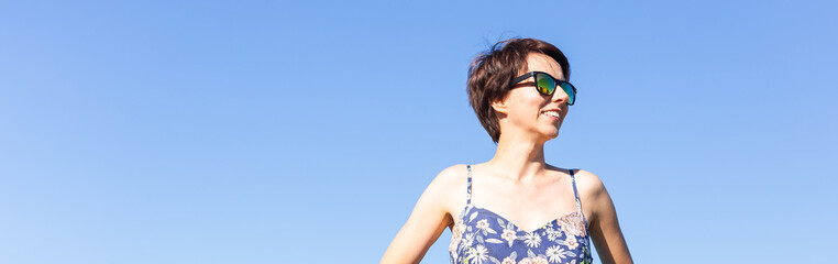 Banner cheerful woman in home wear pajama outdoor on sky background emotions - sleepwear and...