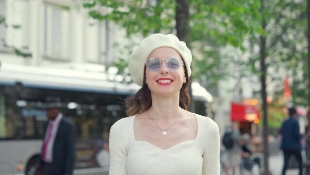 Attractive smiling girl walking on the street in Paris