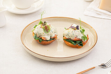 Side view on portion of benedikt egg with dor-blue sauce