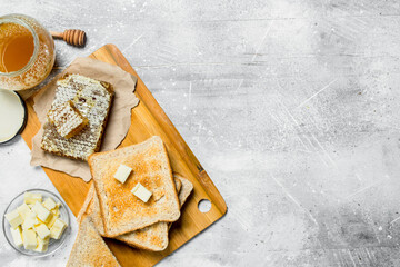 Breakfast. Toasted bread with butter and honey.