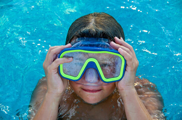 Little boy wearing an Underwater mask in swimming pool 