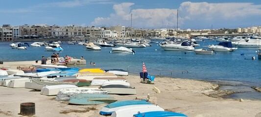Boats on the beach and a beautiful view of the sea  with blue sky and  houses
