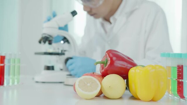 Scientist check chemical food residues in laboratory. Control experts inspect quality of fruits, vegetables. lab, hazards, ROHs, find prohibited substances, contaminate, Microscope, Microbiologist