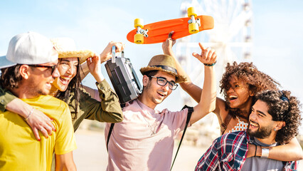 Spring break life style concept with millenial friends having fun together at summer festival by ferris wheel - Happy guys and girls students cheering at sunset on vacation days  - Bright warm filter - 561859726