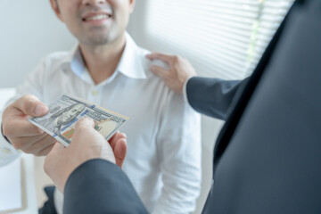 Businessmen receive salary or bonuses from management or Boss. Company give rewards to encourage work. Smiling businessman enjoying a reward at the desk in the office.