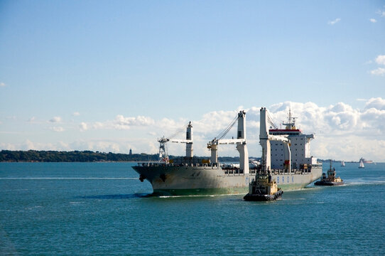 The Cargo Ship Chipolbrok Sun in Southampton Water being towed by tugs