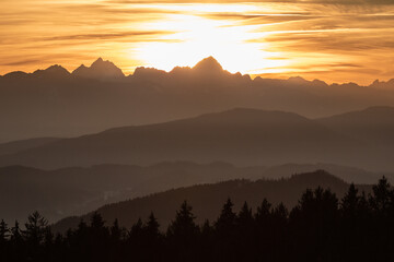 Sunset seen from Lorenziberg over the carithian valleys towards the karawanken mountain range and the Julian alps at the austrian and Slovenian border.