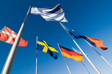 European flags flying against a deep blue sky