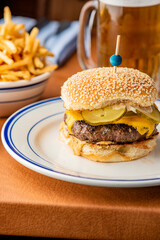 Hamburger. Bacon Cheeseburger. Classic traditional American bar, restaurant entree. Beef hamburger with Swiss and cheddar cheeses served with lettuce, tomato, onion and hand cut french fries. 