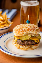Hamburger. Bacon Cheeseburger. Classic traditional American bar, restaurant entree. Beef hamburger with Swiss and cheddar cheeses served with lettuce, tomato, onion and hand cut french fries. 