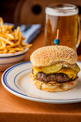 Hamburger. Bacon Cheeseburger. Classic traditional American bar, restaurant entree. Beef hamburger with Swiss and cheddar cheeses served with lettuce, tomato, onion and hand cut french fries. 