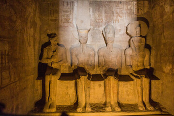 Statues of Ptah, Amun Ra, king Ramesses II and Ra-Horakhty illuminated by the rays of the sun in...