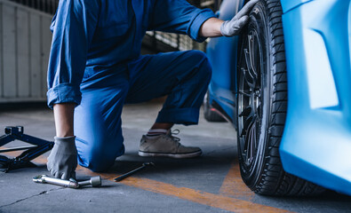 Maintenance worker checking tire service via insurance system at garage, Safety vehicle to reduce accidents before a long travel, road trip transportation.