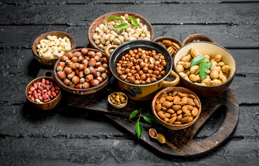 Assortment of different nuts in bowls.