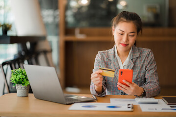 Asian businesswoman enjoying online shopping using credit card and banking transaction