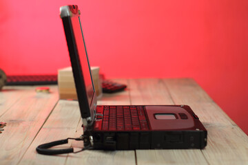 open old laptop on a wooden table by the side with a small depth of field