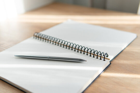 business background. open notepad with pen close-up and blurred foreground.
