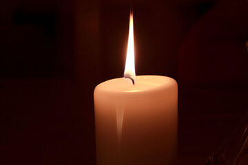 burning candle in the dark