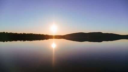 midnight sun over a calm lake