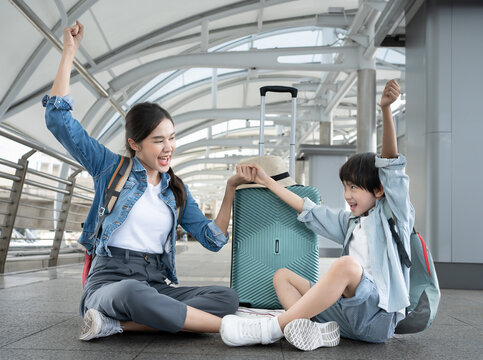 Travel Advertisement. Portrait Of Happy Asian mother Walking With Luggage At Airport, Beautiful Asia Mother, Father And Little Son Going To Boarding, Enjoying Traveling Together