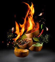 Hot Spices and seasonings powder splash, explosion on black background with flame
