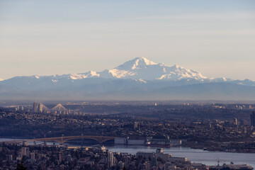 Developed city with industrial and residential buildings. Mount Baker in Background. Vancouver, British Columbia, Canada.