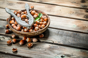 Hazelnuts in a bowl with a Nutcracker.