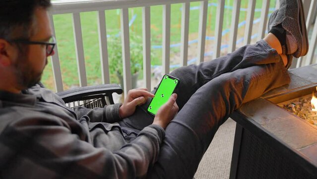 Person scrolling on iphone green screen