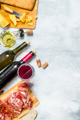 Antipasto background. Red and white wine with meat and cheese appetizers. - 561879776