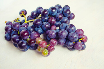 Dark blue grape isolated on white background.