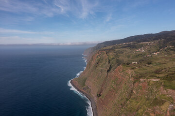 Fototapeta na wymiar Great drone photo of a small village in Madeira built on huge cliffs.