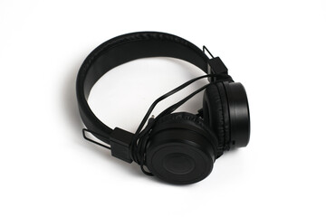 Fototapeta na wymiar Black headphones on a white background. Cheap headphones for listening to music