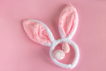 Fototapeta na wymiar Easter background. Pink Easter bunny ears on a pink background. Easter eggs. Easter. copy space