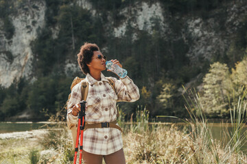 The Woman Enjoys Nature And Drinking Water