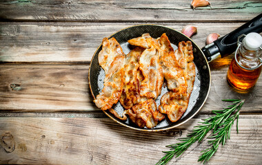 Fried bacon with olive oil and rosemary.