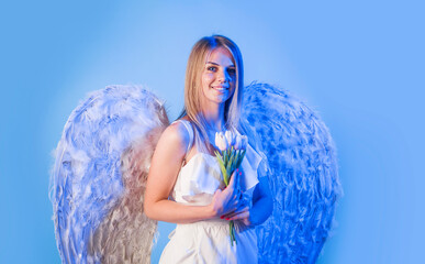 Valentines Day. Woman angel in angelic wings with flowers. Cupid girl in valentine day.