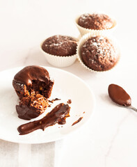 Chocolate muffins on a white plate, on a white background. Fresh chocolate.
