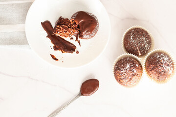 Chocolate muffins on a white plate, on a white background. Fresh chocolate.