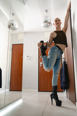 Fototapeta na wymiar Non-binary pole dancer man posing in black high heels. High quality photo