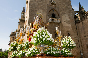 A paso of the Virgin Mary carried in a religious procession past the Cathedral in Seville, Southern Spain.